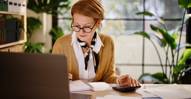 Businesswoman calculating finances
