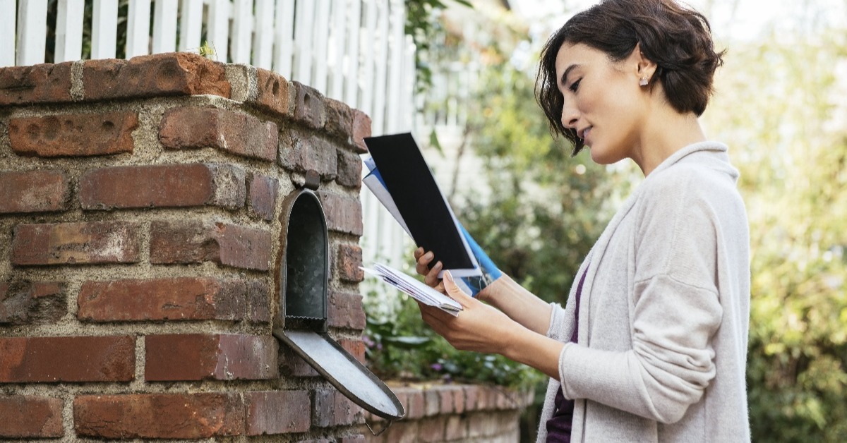 Woman looking at mail in mailbox