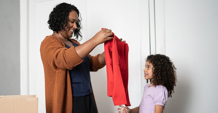 Mother and daughter sorting out clothes_1200x628