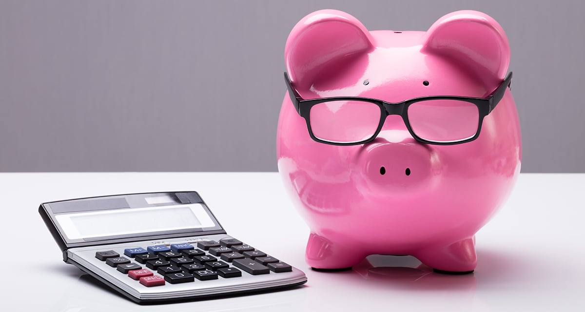 Piggybank with eyeglasses and calculator