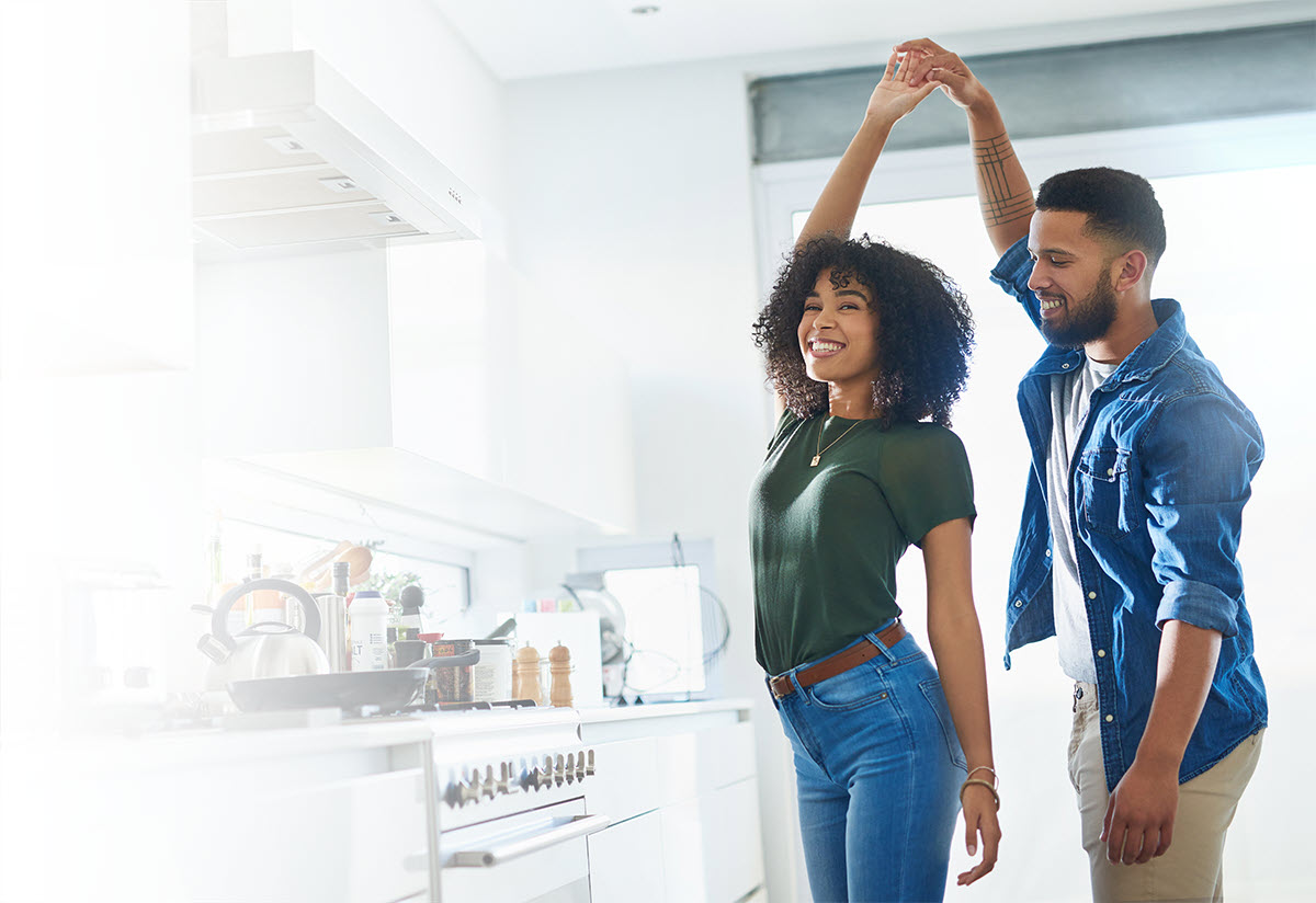 Happy ORHP customers dancing in their kitchen.