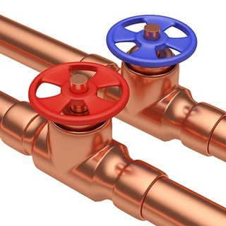 Copper plumbing pipes with hot and cold valves.