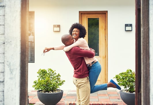 A happy couple that just bought their first home through a DeLex Realty agent.