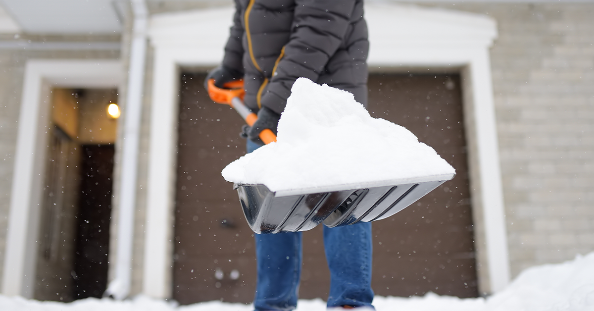 Person shoveling snow out of the driveway