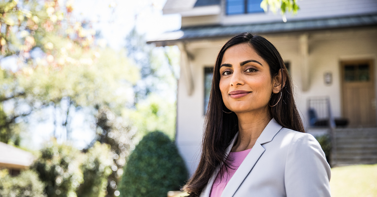 Real estate agent in front of home