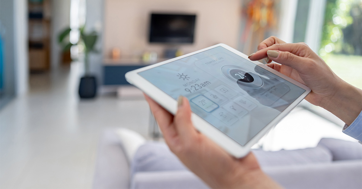 Woman adjusting smart home temperature on tablet